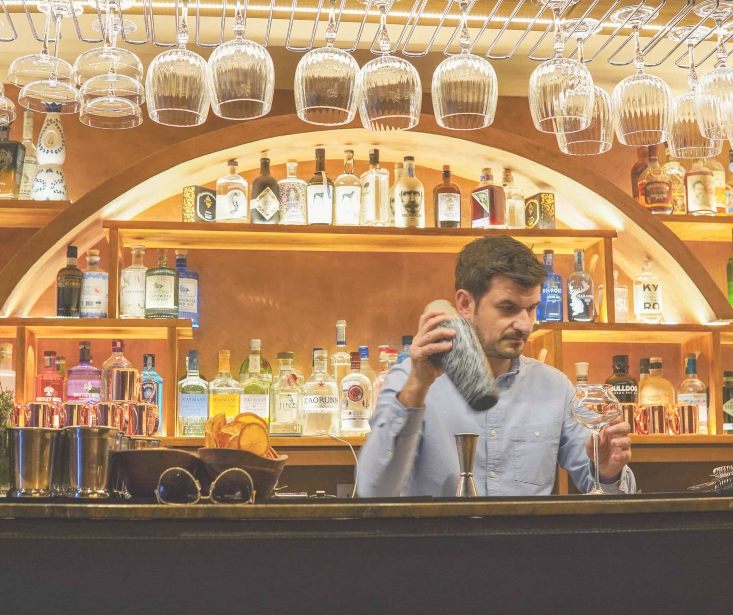 A bartender shaking a drink