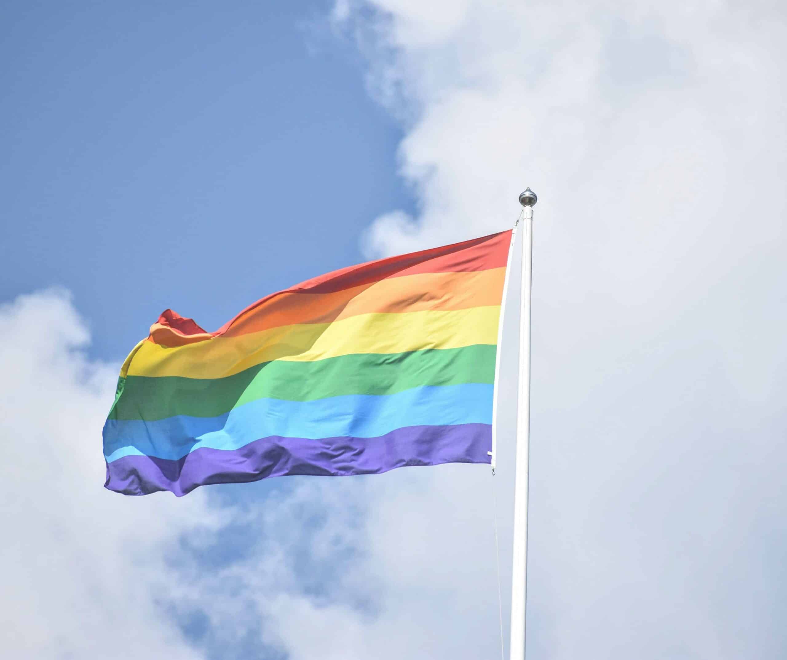 an LGBTQ flag flying