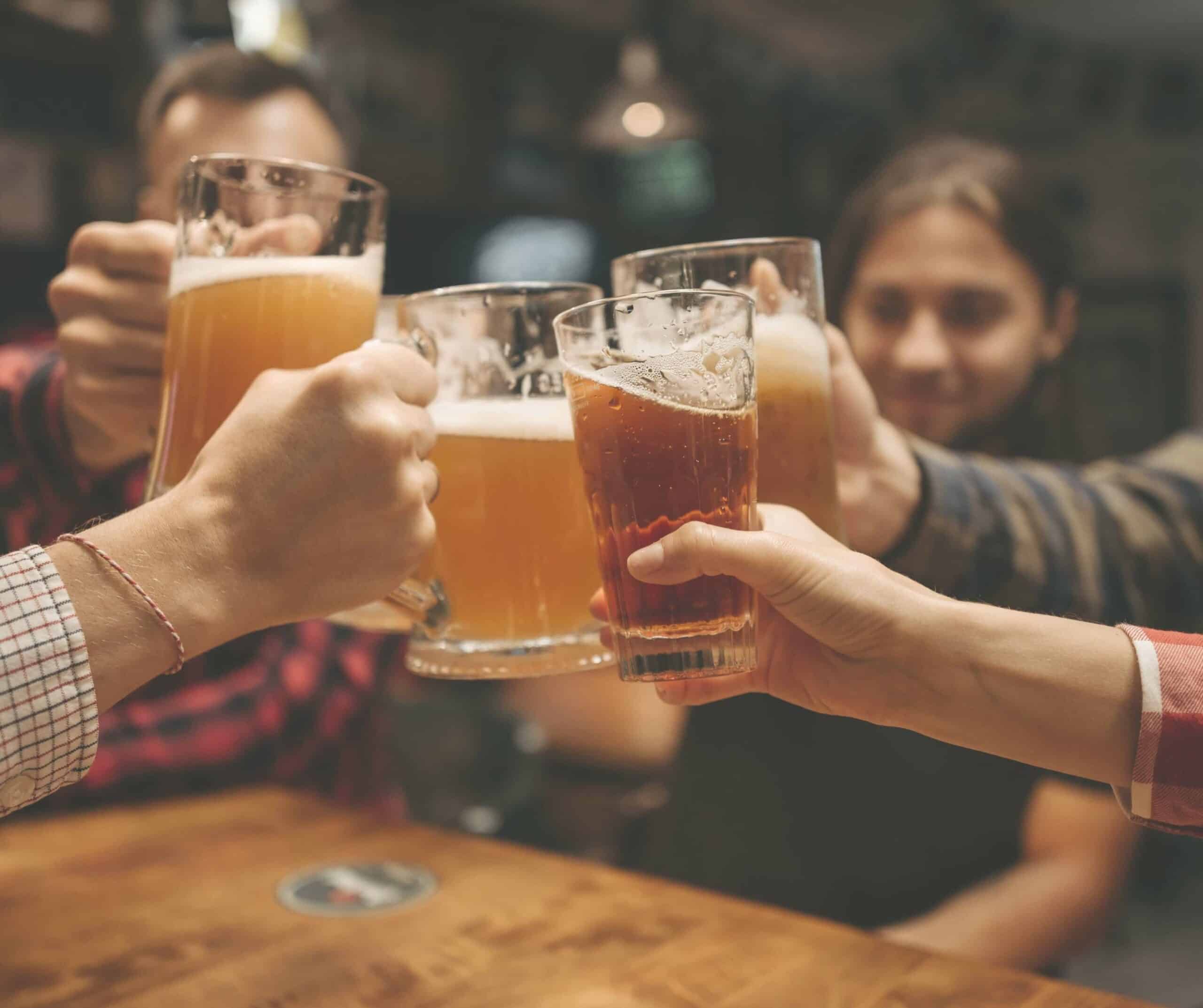 a group of friends cheersing beers